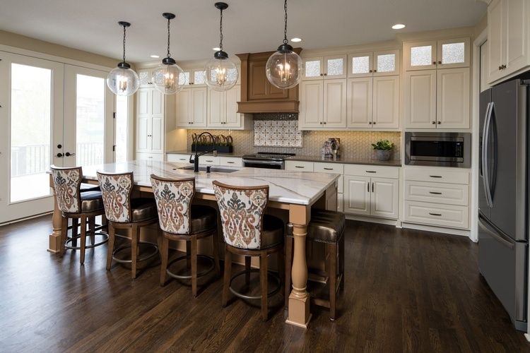 Four lighted pendant lamps above Dining Table - Luxury Kitchen Design in Kansas City by R Designs, LLC