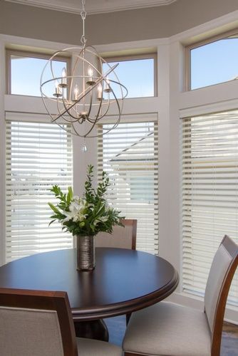Beautiful Chandelier above Dining Table by R Designs, LLC
