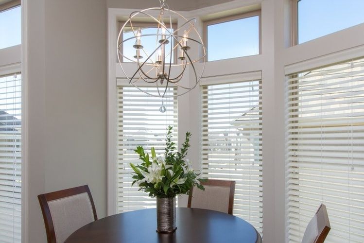 Beautiful Chandelier above Dining Table in Kansas City by R Designs, LLC